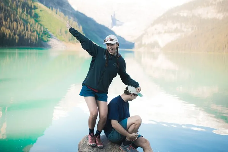 Small group tour at the shoreline of Lake Louise with Victoria Glacier above